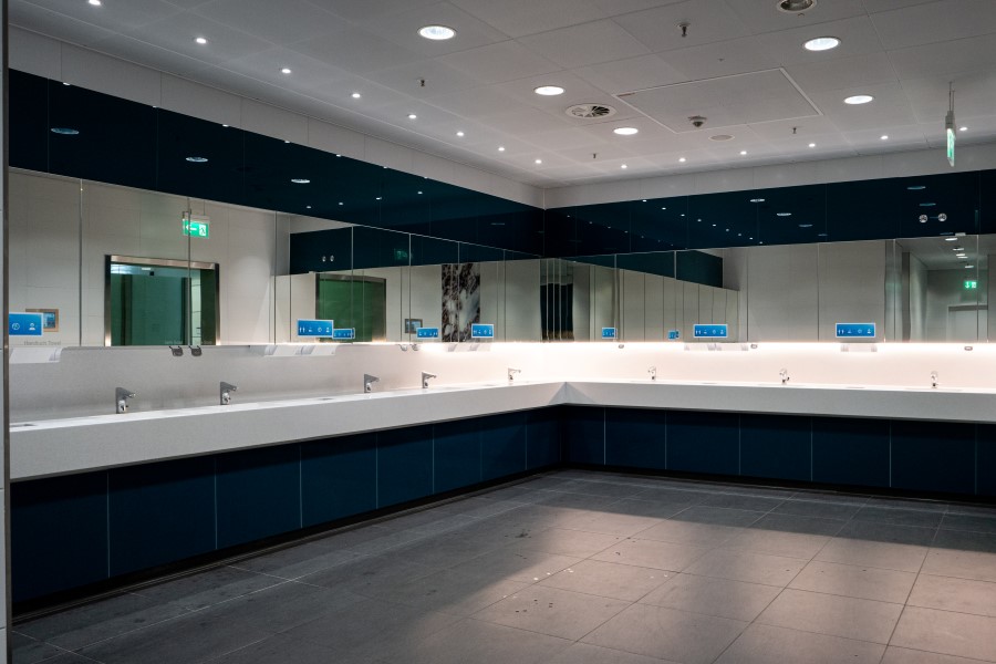 Empty men's public wash room inside international airport terminal